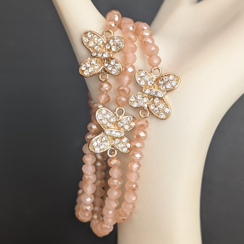 3 peachy pink crystal stretch bracelets with butterfly detail